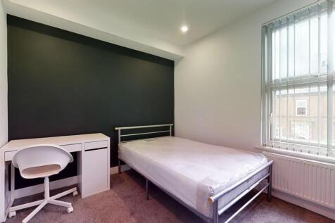 Bright and modern double bedroom featuring a co...