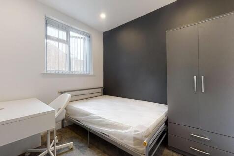 A neat and modern single bedroom featuring a co...