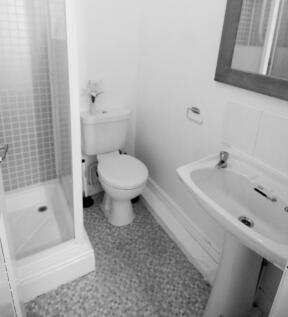 A clean and functional bathroom featuring a sho...