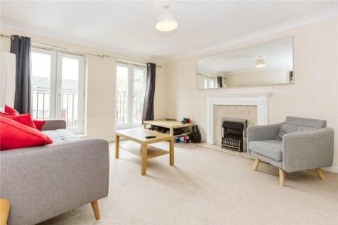 Bright and spacious living room featuring large...