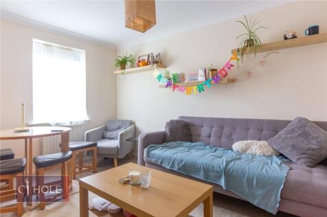 Bright and cozy living room featuring a comfort...