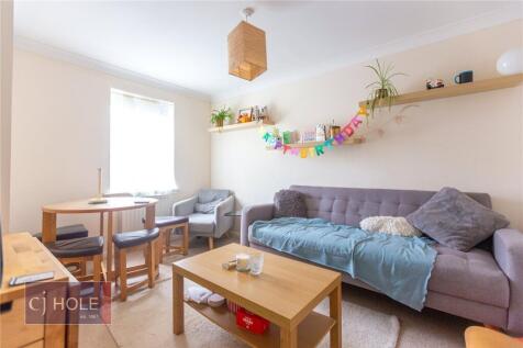 Bright and cozy living room featuring a comfort...