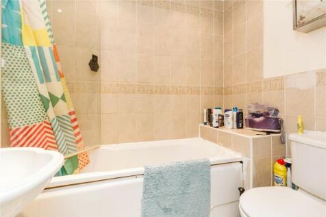 A bright and clean bathroom featuring a full-si...