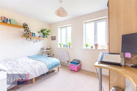 A bright and cozy single bedroom featuring two ...