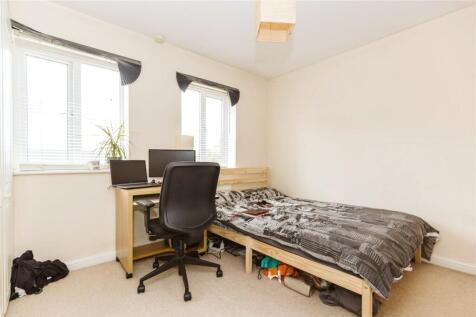 A bright and tidy single bedroom featuring a co...