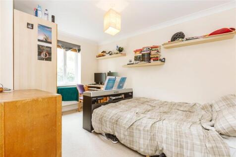 Bright and cozy single bedroom featuring a comf...