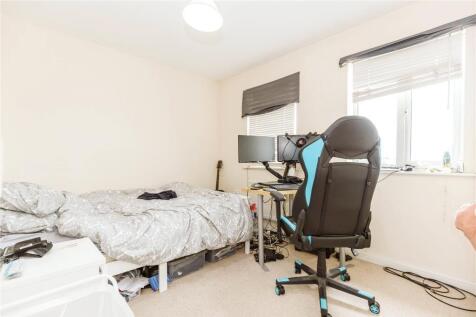 A cozy single bedroom with a comfortable bed, a...