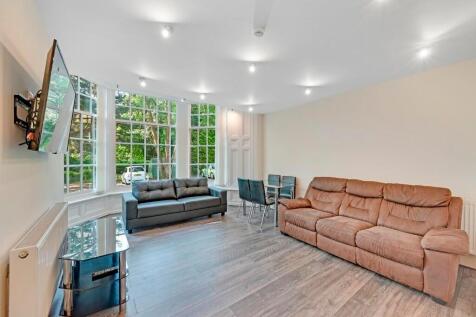 A bright and contemporary living room featuring...