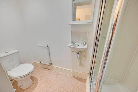 A clean and functional bathroom suite featuring...