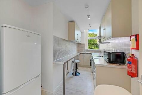 Bright and modern kitchen with ample natural li...