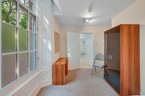 A bright and tidy hallway featuring a large win...