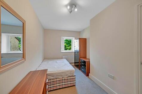 Bright and tidy bedroom featuring a comfortable...