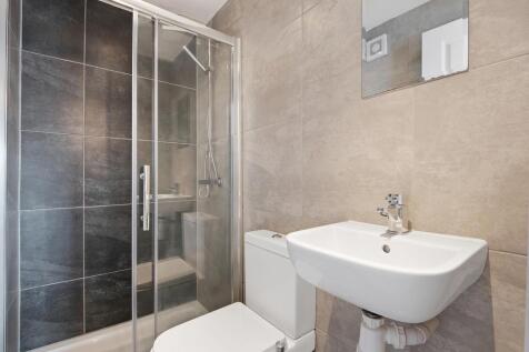 A modern and clean bathroom suite featuring a s...