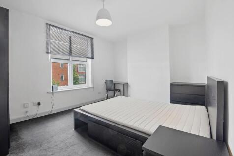 A neat and well-lit double bedroom featuring a ...