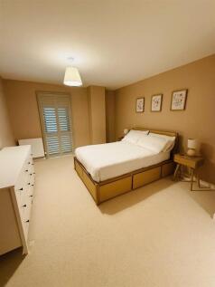 A spacious and inviting master bedroom featurin...