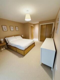A spacious and well-organized master bedroom fe...