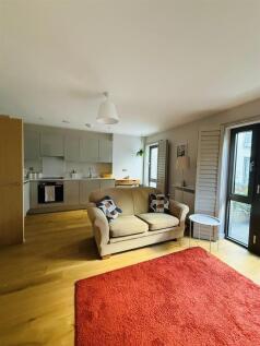 Bright and inviting open-plan living room featu...