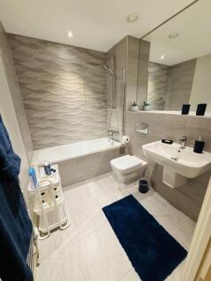 A modern, well-maintained bathroom suite featur...
