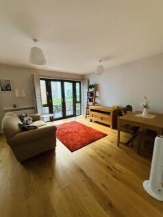 Bright and welcoming living room featuring warm...