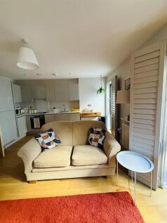 A modern living room featuring a comfortable be...