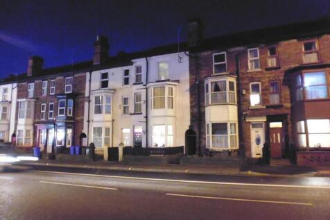 A nighttime street view of a charming row of te...