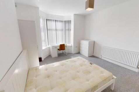 A bright and spacious master bedroom featuring ...