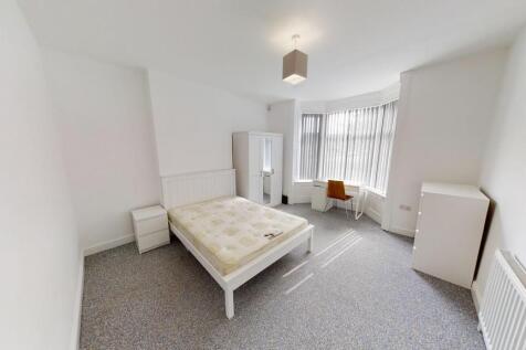 Bright and airy double bedroom featuring a larg...