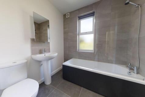 Bright and modern bathroom featuring a full bat...
