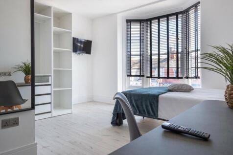 Bright and spacious double bedroom featuring a ...
