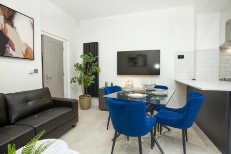 This stylish living room features a modern desi...