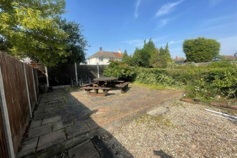 Spacious garden area featuring a rustic seating...