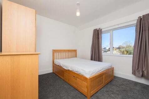 Bright and tidy double bedroom featuring a comf...
