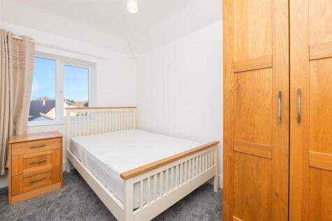Bright and tidy double bedroom featuring a comf...