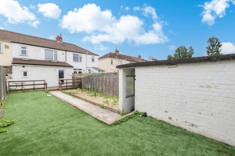 A well-maintained garden area featuring a neat ...