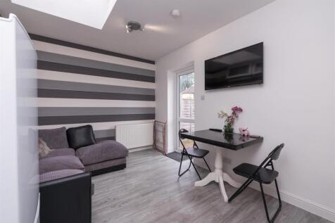 Contemporary living room featuring stylish stri...