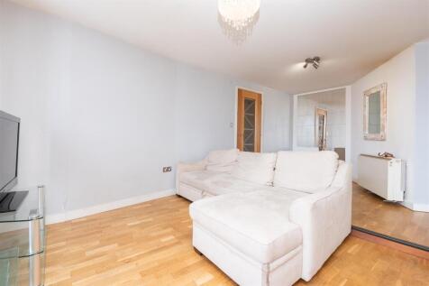 Bright and inviting living room featuring a lar...