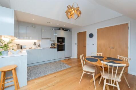 A stylish modern kitchen featuring sleek cabine...