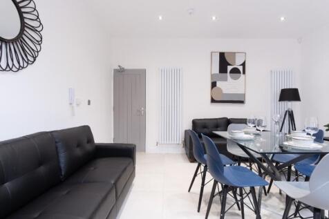 A modern and inviting living room featuring sle...