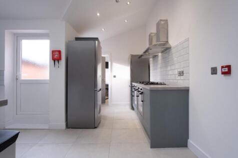 Bright and modern kitchen featuring ample count...