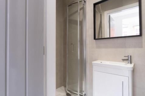 A modern bathroom featuring a sleek shower, con...
