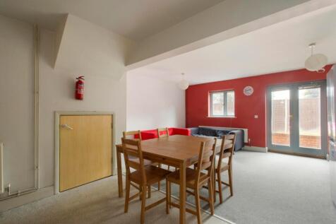A spacious communal lounge featuring a cozy din...
