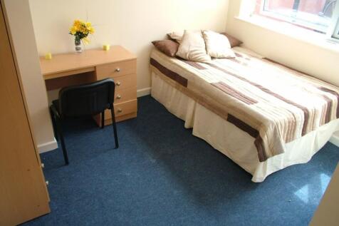 Cozy double bedroom featuring a comfortable bed...