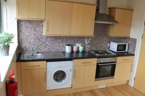 This modern kitchen features stylish cabinetry ...