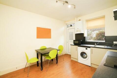 Bright and tidy kitchen featuring modern applia...