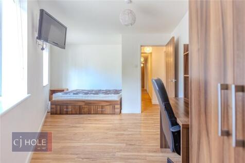 Bright and spacious master bedroom featuring a ...