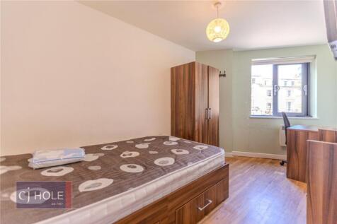 Bright and tidy single bedroom featuring a wood...