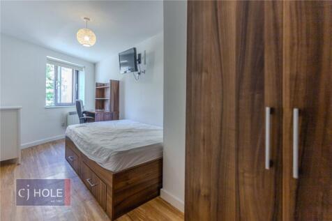 A bright and tidy single bedroom featuring a co...