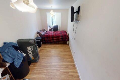 A narrow, clean hallway-style room with a woode...