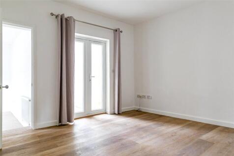 Bright and airy double bedroom with fresh white...