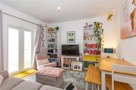 Bright and cozy living room featuring comfortab...